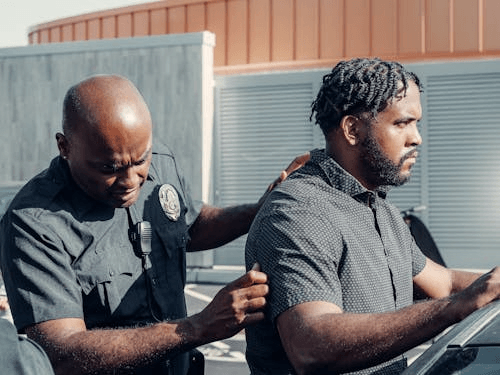 Police officer detaining a man during arrest illustrating civil rights violations in Pennsylvania